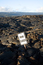 Lava flow over the Chain of Craters Road, with road closed sign, in Hawai'i Volcanoes National Park. The Big Island of Hawaii, USA, December 2008