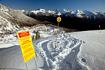 Ski at own risk sign. Mount Baker Ski Area in the North Cascades. Washington, USA, April 2009