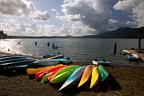 Kayaks on beach at boat dock and launch area on Quinault Lake at Lake Quinault Lodge. Washington, USA, September 2009