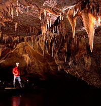 Man standing in Moses walk cave, Marble Arch Caves, County Fermanagh, Northern Ireland, UK