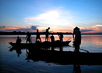 Silhouette of fishermen on Ayapua Lake, Purus River, hauling in catch. Piagacu-Purus Sustainable Development Reserve, Amazonas State, Brazil. April 2004