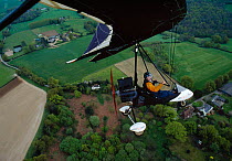 Stephen Dalton (photographer) in a microlight flying over the Sussex countryside, UK