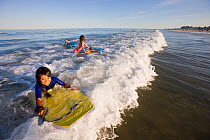 Children on boogie boards at Hampton Beach, New Hampshire, USA, August 2008. Model released.