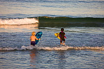 Children with boogie boards on Hampton Beach, New Hampshire, USA, August 2008. Model released.