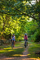 Two women biking at Odiorne State Park, Rye, New Hampshire, USA. September 2008, Model released.