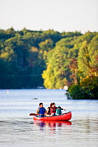 Family canoeing on Pawtuckaway Lake, Pawtuckaway State Park, New Hampshire, USA, September 2008. Model released.