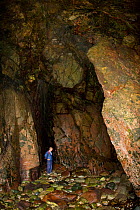 Man exploring the Boutique Caves, Sark, Channel Isles, UK, 2009