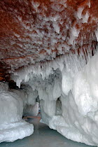 Ice hanging from sea cave carved in soft sandstone cliffs, Squaw Bay, Lake Superior, Apostle Islands National Lakeshore, Wisconsin, USA, February 2009