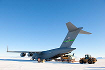 Unloading equipment from the US Military aeroplane, C17 Globemaster, parked on the Pegasus White Ice Runway, McMurdo Sound, Ross Sea, Antarctica, November 2008