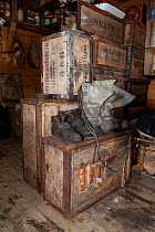 Boots and wooden packing cases in interior of Shackleton's Nimrod Hut, frozen in time from the British Antarctic Expedition 1907, Cape Royds, McMurdo Sound, Antarctica, November 2008