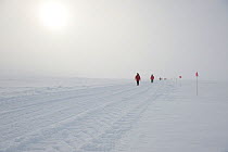 BBC film crew walking along ice road, McMurdo Sound, Ross Sea, Antarctica, November 2008