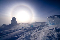 Sundog / Parhelion (circle of light around the sun) with large ice fumerole in the foreground, McMurdo Sound, Ross Sea, Antarctica, November 2008