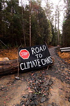 Conservationists protest  sign "Stop Road to Climate Chaos" against the felling of old growth trees in Tasmania's pristine Florentine, southwest Tasmania, Australia March 2007