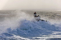 Waves crashing around Tevennec lighthouse in the Sein channel, Finistère, Brittany, France. December 2007.