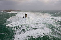 Waves crashing around La Vieille lighthouse (33 metres) off La Pointe du Raz, Finistère, Brittany, France. December 2007.