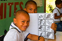 Colombian students proudly display educational material designed to teach them about primates in their forests. Los Limites, Colombia. South America. February 2008 *Editorial release only*