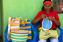 Colombian woman knitting mochilas and other products woven from recycled plastic bags. This project has recycled more than 1.5 million plastic bags and provides an income to the village living around...