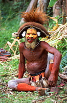 Huli man in traditional dress, Tari Valley, Papua New Guinea, during filming for BBC series Planet Earth.