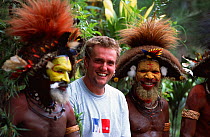 Cameraman Tom Clarke, with Huli wigmen dressed in traditional clothing, Tari Valley, Papua New Guinea, during filming for the BBC Planet Earth series, August 2004.