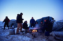 Film crew around campfire and tents with their guides for filming wild bactrian camels, Great Gobi National Park, Gobi Desert, Mongolia for Deserts episode of BBC NHU TV series Planet Earth, January 2...