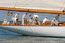 Crew members all in white on the aftdeck of gaff cutter "Mariquita". Westward Cup Regatta, Cowes, Isle of Wight. July 2010.