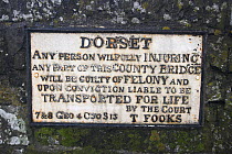 Dorset sign on Sturminster Newton bridge. Many have been taken by collectors or thieves. Dorset, England, UK. March 2009