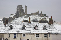 The Greyhound Pub in snow, with Corfe Castle behind, Dorset, England, UK. March 2009