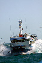 Fishing vessel "Harvester" ploughing through a wave, North Sea, May 2010.