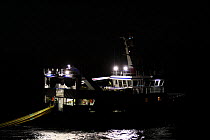 Fishing vessel "Harvester" hauling fishing gear in the dark, May 2010. Property released.