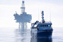 Fishing vessel "Harvester" and the "Jotun B" oil production platform. North Sea, May 2010.