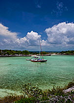 30ft Tiki catamaran "Abaco" anchored in a secluded cove in the Exumas, Bahamas, Caribbean. June 2009. Property Released.