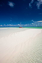 30ft Tiki catamaran "Abaco" pulled up near sand bank in the Exumas, Bahamas, Caribbean. June 2009. Property released.