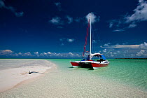 30ft Tiki catamaran "Abaco" anchored by sand bank in the Exumas, Bahamas, Caribbean. June 2009. Property released.