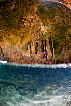 People exploring a cave in the Exumas, Bahamas, Caribbean. June 2009, Model released.