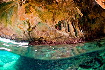People exploring a cave in the Exumas, Bahamas, Caribbean. June 2009, Model released.