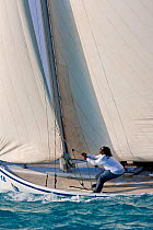 Man trimming sail during the Bahamian Sloop regatta, Georgetown, Exumas, Bahamas. April 2009.