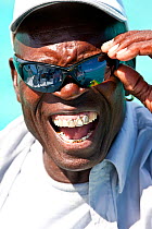 Man with sunglasses and gold teeth in the Grenadines, Caribbean, February 2010.
