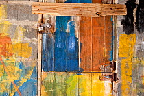 Roughly painted, colourful wooden doors of a building in the Grenadines, Caribbean. February 2010.