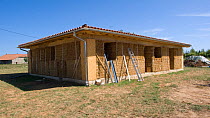 House being built using straw bales, an ideal material for insulation, France, August 2009