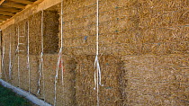 House being built using straw bales, an ideal material for insulation, France, August 2009