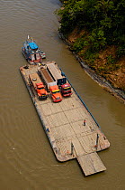 Aerial view of Napo river and barge used to transport oil vehicles Yasuni National Park Biosphere Reserve Amazon Rain Forest. Ecuador, South America, November 2004