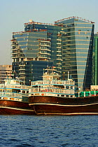 Traditional freight-carrying dhows loading up along Dubai creek, Dubai, United Arab Emirates, February 2010