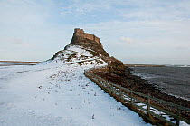 Lindisfarne castle in snow covered landscape Holy Island, Northumberland, UK, January 2010