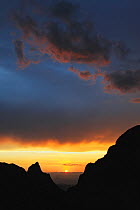 View of 'The Window' at sunset. This is an opening between two peaks which plays an important role in preserving Chisos Basin's ecosystem. Chisos Mountains, Big Bend National Park, Chihuahuan Desert,...