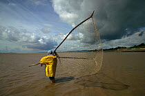 Traditional lave net fisherman (a method dating back at least 1,500 years) holding net for fishing for salmon. This Severn Estuary way of life is threatened by proposed barrage. Gloucestershire, Engla...