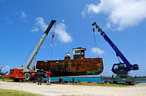 Tug boat raised above water on two cranes, for BBC Filming 'Life' The Bahamas, Caribbean, August 2007