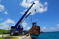 Tug boat on hoist, being moved for the purpose of BBC Life series, The Bahamas, Caribbean, August 2007