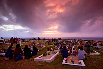 Islanders visiting the cemetery and watching the sunset on All Saints Day (Day of the Dead), Hanga Roa, Easter Island  (Rapa Nui), Pacific ocean, November 2004