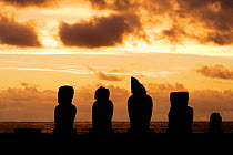 Silhouette of Moai statues at sunset at the restored archaeological site of Ahu Vai Uri, Tahai Ceremonial center, Hanga Roa, Easter Island, Pacific ocean, November 2004