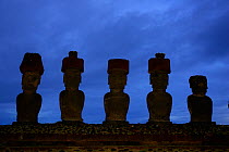 Silhouette of five giant Moai statues in Ahu Nau Nau at dawn, Anakena beach, Easter Island, Pacific ocean, November 2004